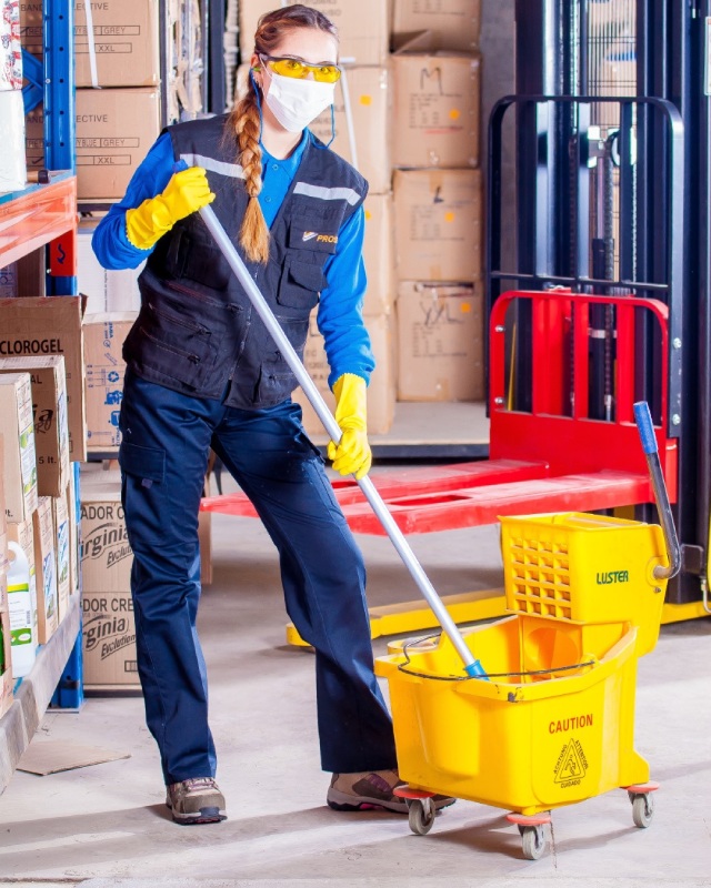 Cleaning technician mopping a floor at a Chicago commercial cleaning clients location